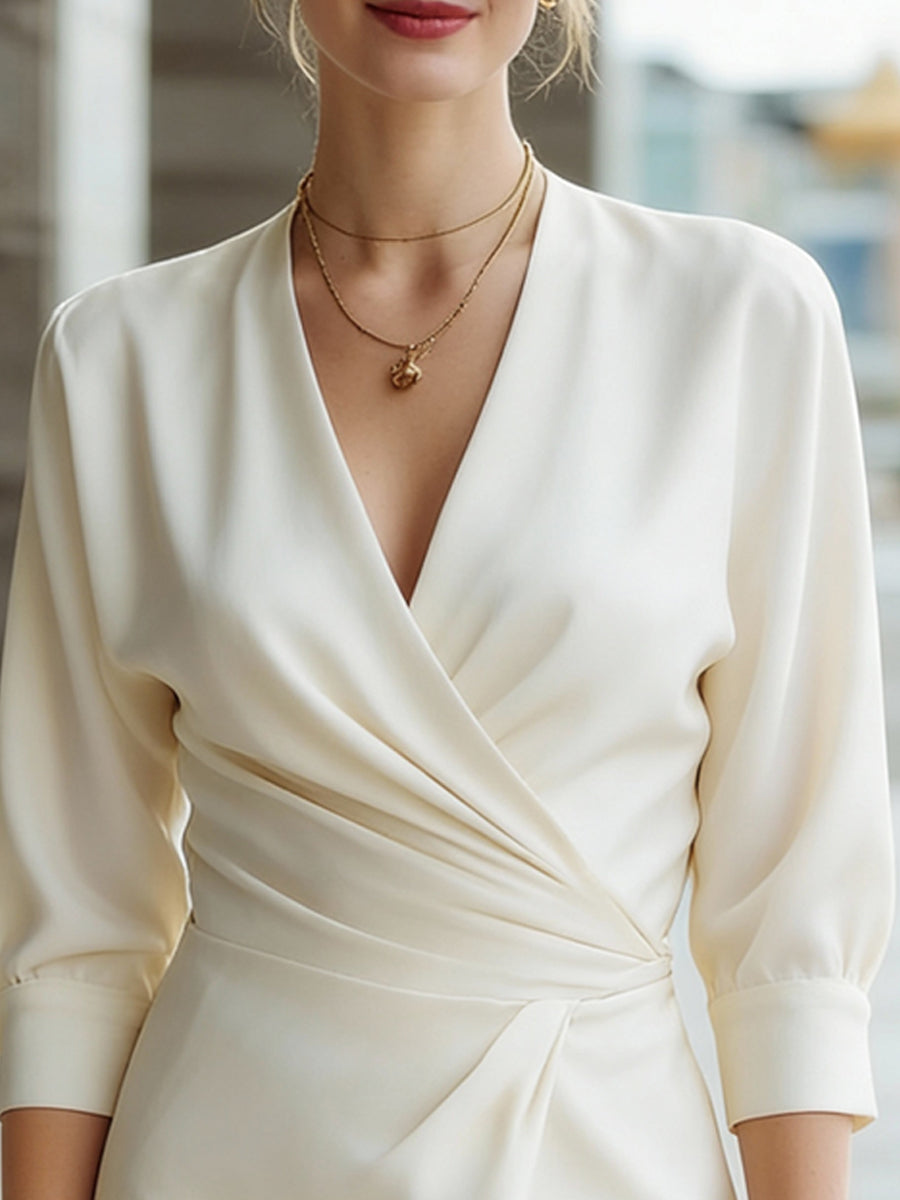 Elegantna midi obleka z drapiranjem in V-izrezom